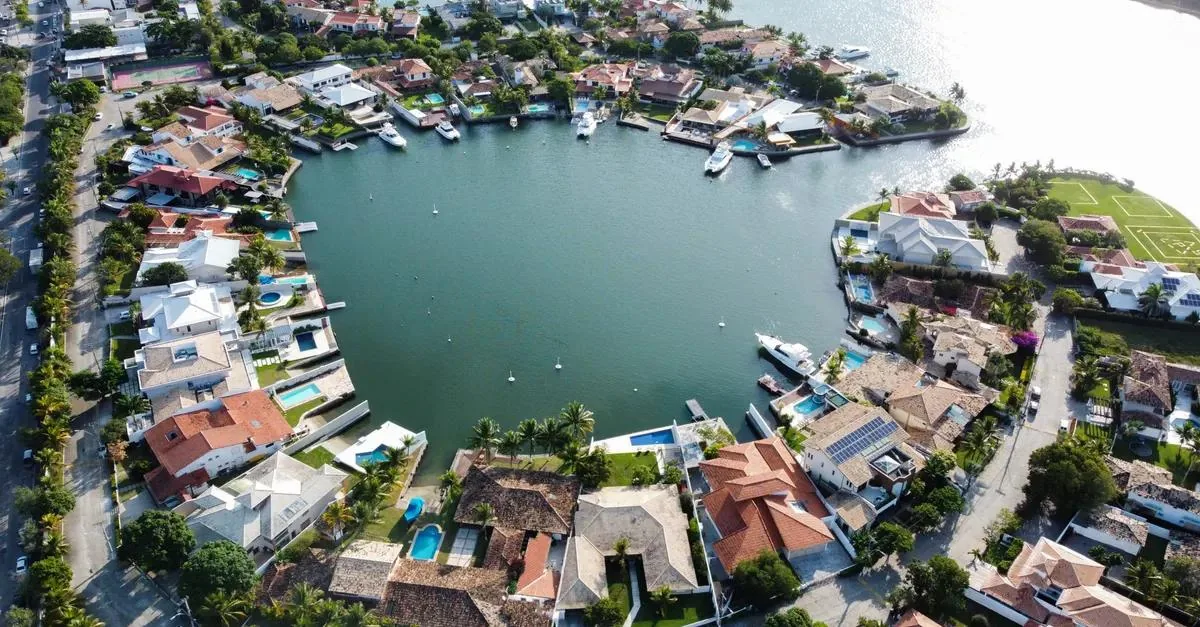 Aerial view of waterfront homes in a luxury coastal neighborhood